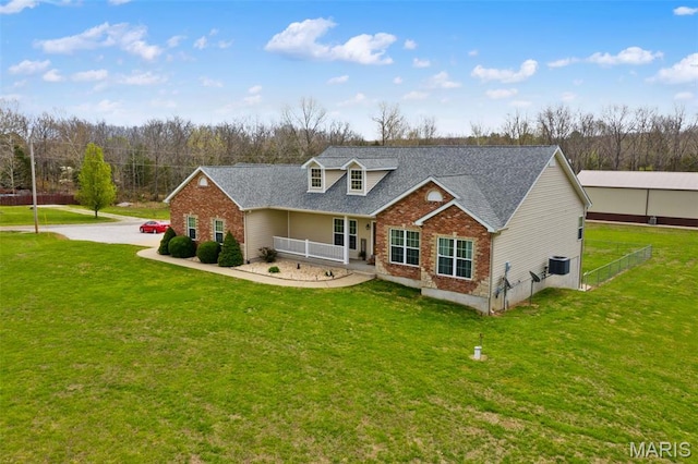 back of property featuring brick siding, central AC unit, roof with shingles, and covered porch