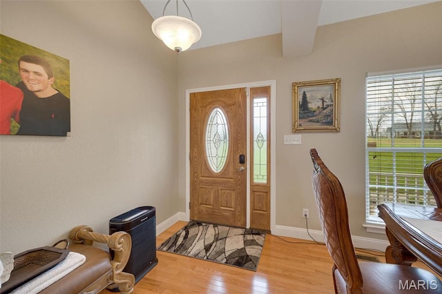 entryway featuring plenty of natural light, light wood-style floors, and baseboards