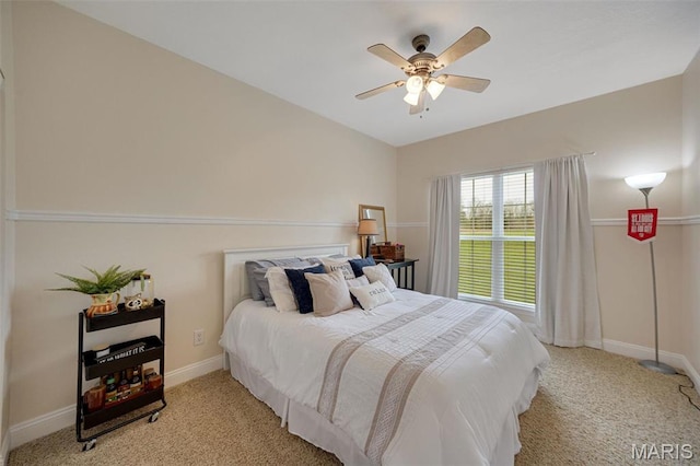 bedroom featuring light carpet, baseboards, and ceiling fan