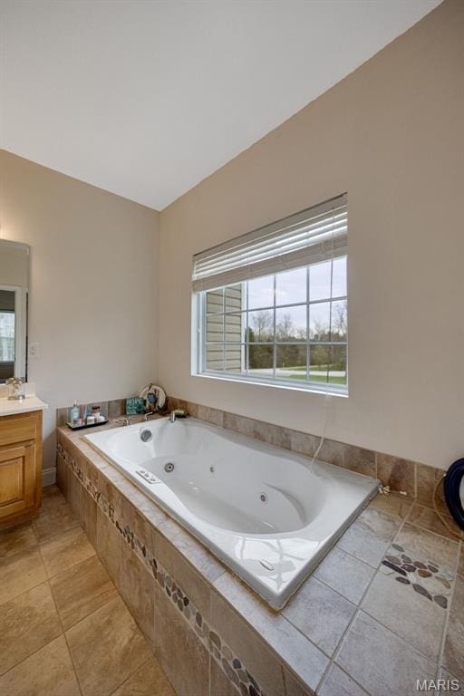 full bath with vanity, a whirlpool tub, and tile patterned floors