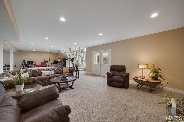 living room featuring stairway, light colored carpet, baseboards, and recessed lighting
