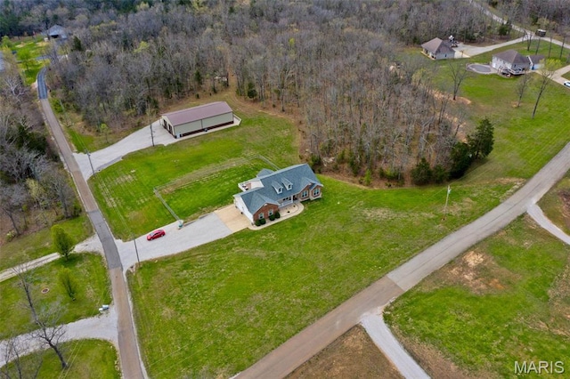 aerial overview of property's location with a heavily wooded area