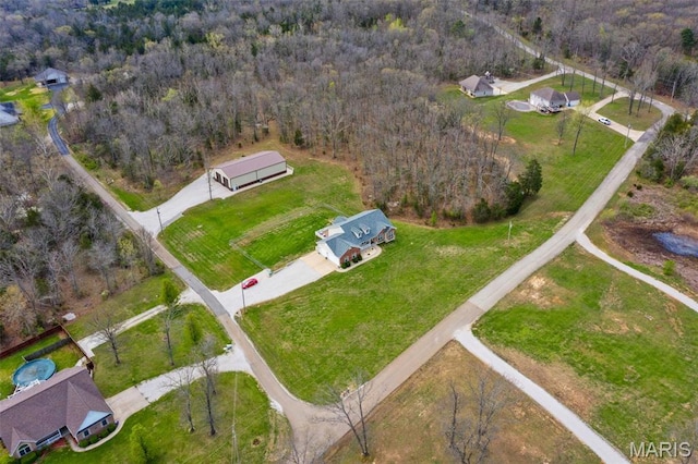 view of property location featuring a forest