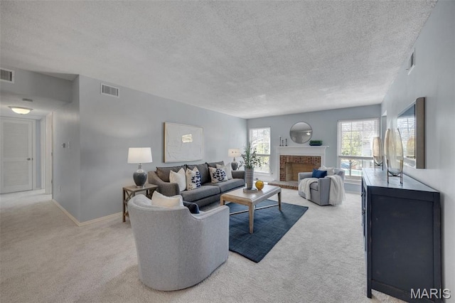 living area featuring carpet, a textured ceiling, baseboards, and a brick fireplace