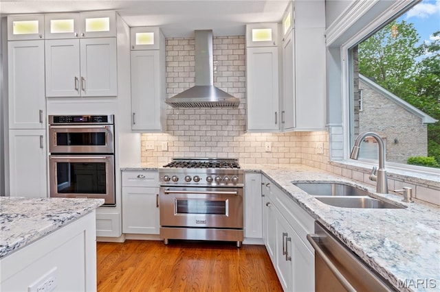 809 Star Ridge Ct, Defiance, MO 63341 - kitchen with wall chimney range hood, stainless steel appliances, and white cabinets