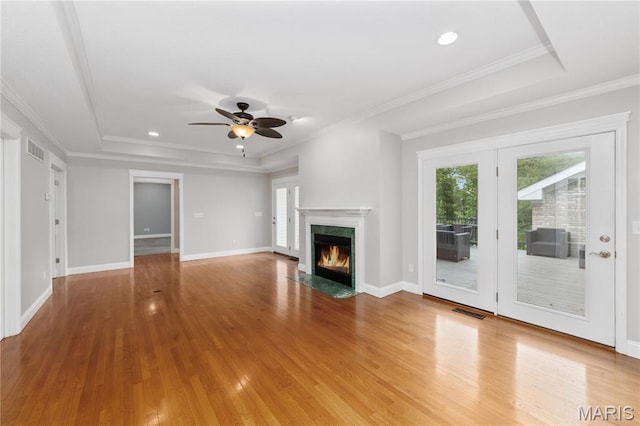 809 Star Ridge Ct, Defiance, MO 63341 - unfurnished living room featuring wood finished floors, a ceiling fan, a tray ceiling, a fireplace, and recessed lighting