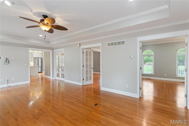 809 Star Ridge Ct, Defiance, MO 63341 - unfurnished room featuring a tray ceiling, french doors, a ceiling fan, light wood-style floors, and crown molding