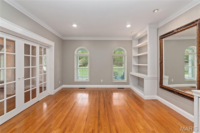 809 Star Ridge Ct, Defiance, MO 63341 - empty room featuring light wood finished floors, crown molding, french doors, recessed lighting, and built in shelves