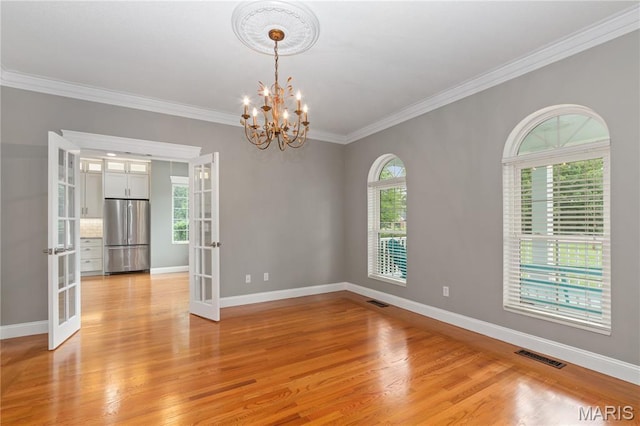 809 Star Ridge Ct, Defiance, MO 63341 - unfurnished room with french doors, light wood finished floors, ornamental molding, and a chandelier