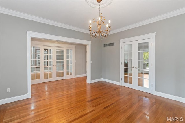 809 Star Ridge Ct, Defiance, MO 63341 - spare room with french doors, a chandelier, crown molding, and wood finished floors