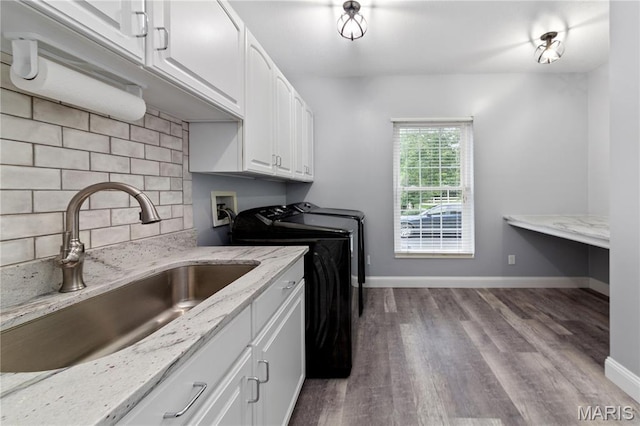 809 Star Ridge Ct, Defiance, MO 63341 - laundry room with washing machine and clothes dryer, cabinet space, and wood finished floors