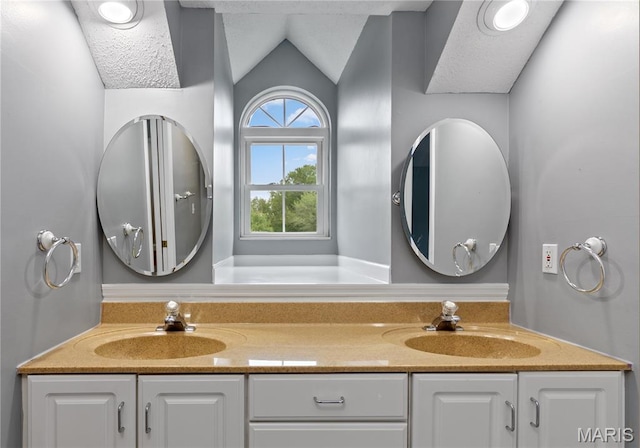 809 Star Ridge Ct, Defiance, MO 63341 - bathroom with double vanity and lofted ceiling