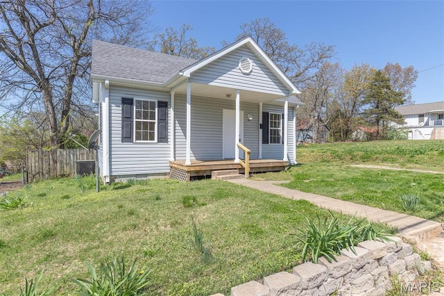 view of front of property featuring roof with shingles, a porch, and cooling unit