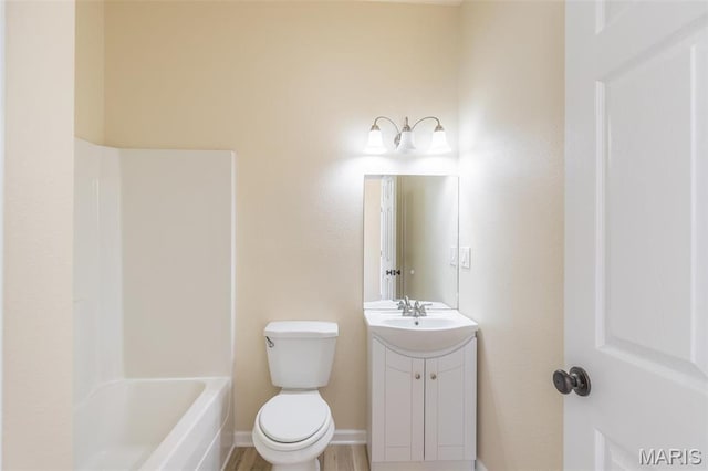 full bathroom with vanity, toilet, and baseboards
