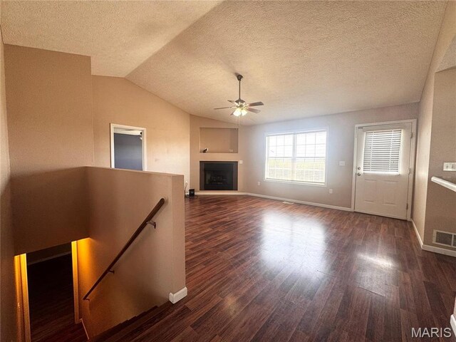 18410 Charity Dr, Dixon, MO 65459 - unfurnished living room with dark wood-type flooring, a textured ceiling, ceiling fan, baseboards, and lofted ceiling