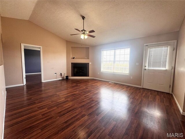 18410 Charity Dr, Dixon, MO 65459 - unfurnished living room featuring ceiling fan, lofted ceiling, wood finished floors, a fireplace with raised hearth, and baseboards