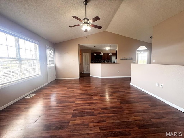 18410 Charity Dr, Dixon, MO 65459 - unfurnished living room featuring a ceiling fan, dark wood-style flooring, vaulted ceiling, a textured ceiling, and baseboards
