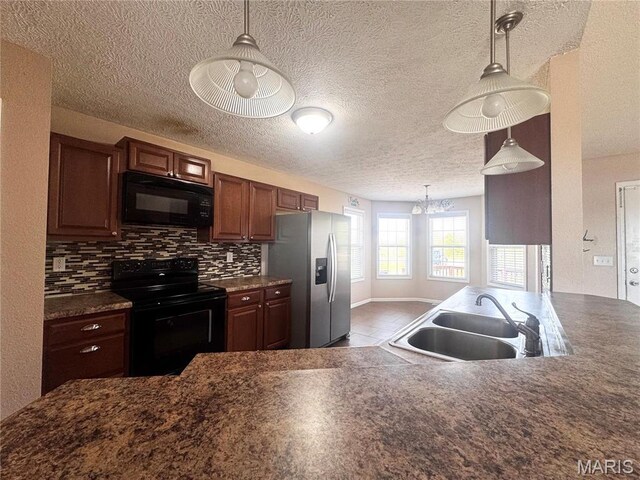 18410 Charity Dr, Dixon, MO 65459 - kitchen featuring black appliances, a sink, dark countertops, tasteful backsplash, and a textured ceiling