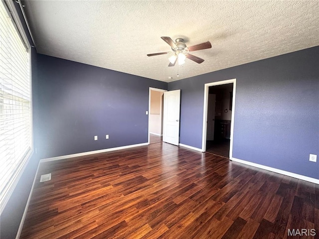 18410 Charity Dr, Dixon, MO 65459 - unfurnished bedroom featuring wood finished floors, baseboards, a textured ceiling, a ceiling fan, and ensuite bathroom