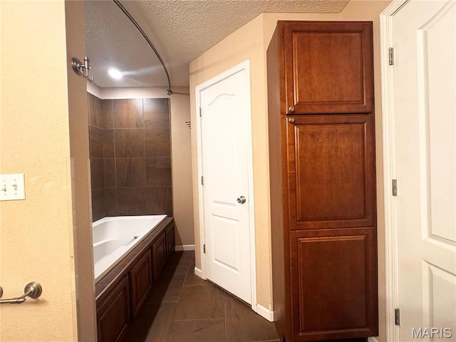 18410 Charity Dr, Dixon, MO 65459 - bathroom with a textured ceiling, baseboards, and bathing tub / shower combination