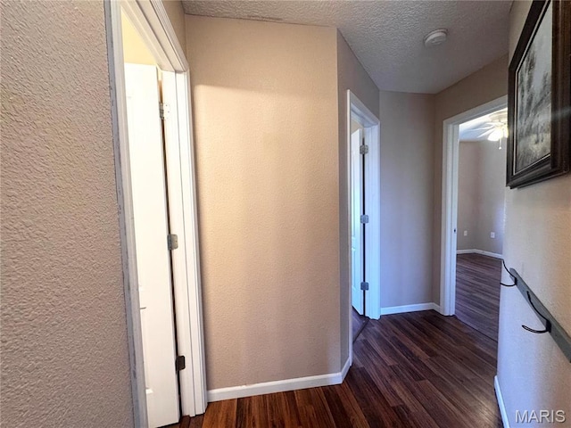 18410 Charity Dr, Dixon, MO 65459 - corridor with dark wood finished floors, baseboards, a textured ceiling, and a textured wall