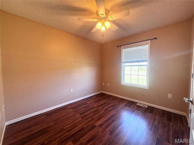 18410 Charity Dr, Dixon, MO 65459 - spare room featuring a textured ceiling, dark wood-style flooring, baseboards, and a ceiling fan
