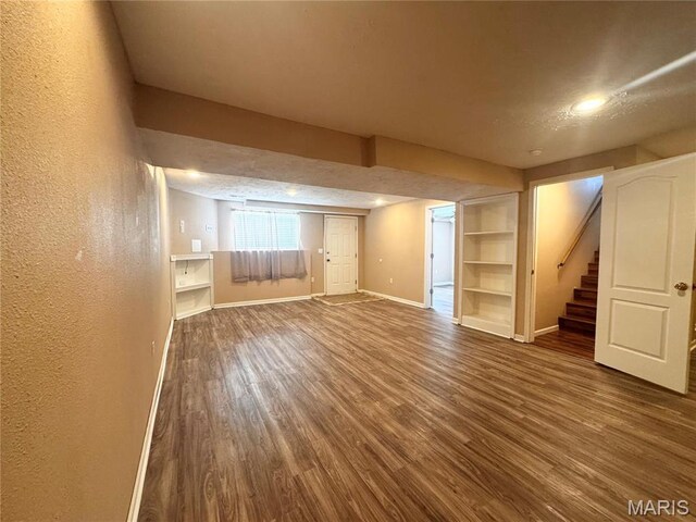 18410 Charity Dr, Dixon, MO 65459 - below grade area featuring a textured wall, baseboards, wood finished floors, stairway, and built in features