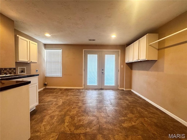 18410 Charity Dr, Dixon, MO 65459 - kitchen with baseboards, white cabinetry, dark countertops, french doors, and recessed lighting