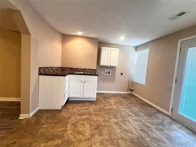 18410 Charity Dr, Dixon, MO 65459 - laundry room featuring hookup for an electric dryer, cabinet space, washer hookup, baseboards, and a textured ceiling