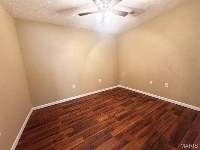 18410 Charity Dr, Dixon, MO 65459 - empty room with dark wood-type flooring, a ceiling fan, a textured ceiling, and baseboards