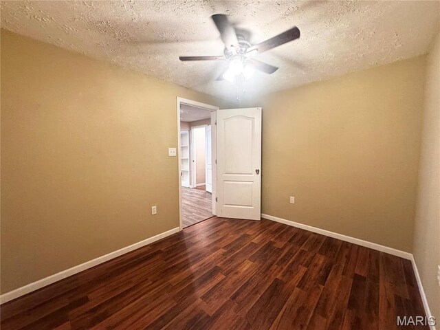 18410 Charity Dr, Dixon, MO 65459 - unfurnished room featuring dark wood-style flooring, ceiling fan, a textured ceiling, and baseboards