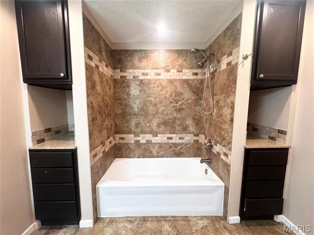 18410 Charity Dr, Dixon, MO 65459 - full bathroom with shower / tub combination, a textured ceiling, and baseboards