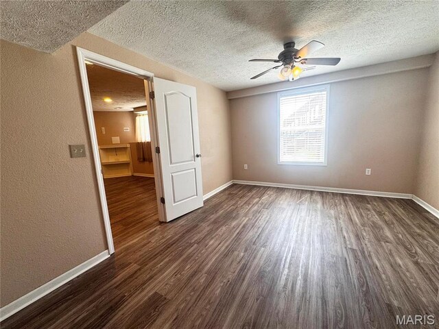 18410 Charity Dr, Dixon, MO 65459 - spare room with baseboards, a ceiling fan, dark wood-type flooring, a textured ceiling, and a textured wall