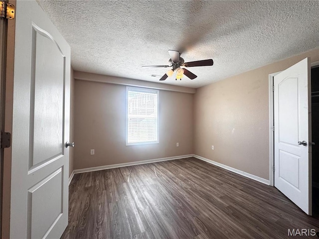 18410 Charity Dr, Dixon, MO 65459 - empty room with a ceiling fan, dark wood finished floors, baseboards, and a textured ceiling