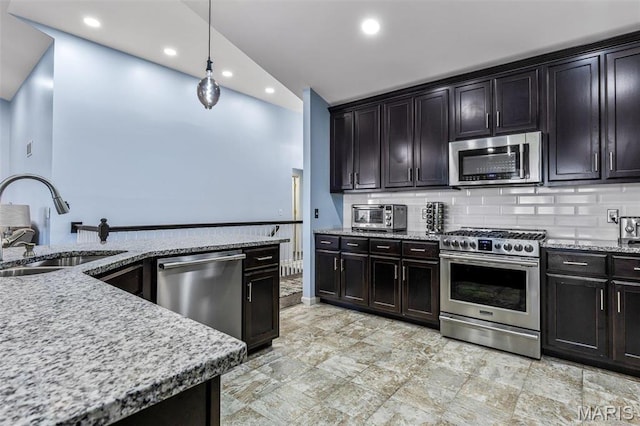 1869 Sunset Rdg, Festus, MO 63028 - kitchen with stainless steel appliances, a sink, light stone counters, recessed lighting, and decorative backsplash
