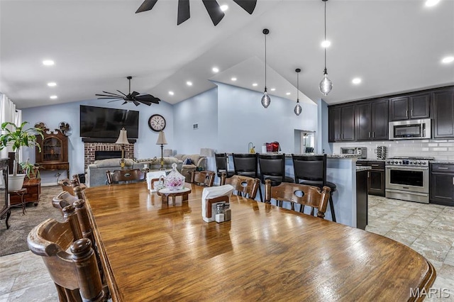 1869 Sunset Rdg, Festus, MO 63028 - dining room with a ceiling fan, lofted ceiling, a fireplace, and recessed lighting