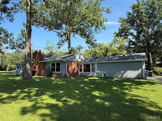 10074 Briarwood Dr, Ladue, MO 63124 - back of house with a lawn, brick siding, and a chimney