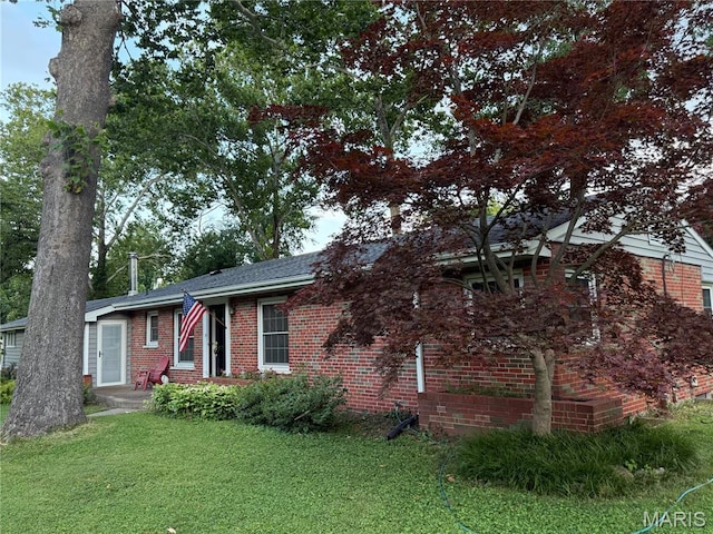 10074 Briarwood Dr, Ladue, MO 63124 - view of property hidden behind natural elements featuring brick siding and a front lawn