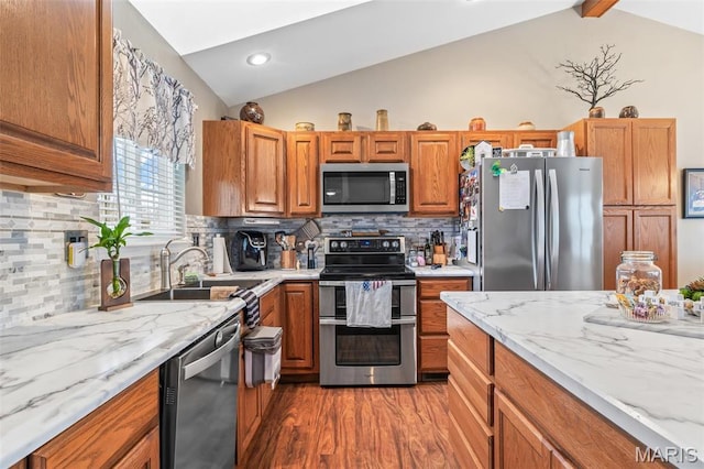 790 Isabella Ct, Farmington, MO 63640 - kitchen featuring appliances with stainless steel finishes, lofted ceiling, a sink, wood finished floors, and light stone counters