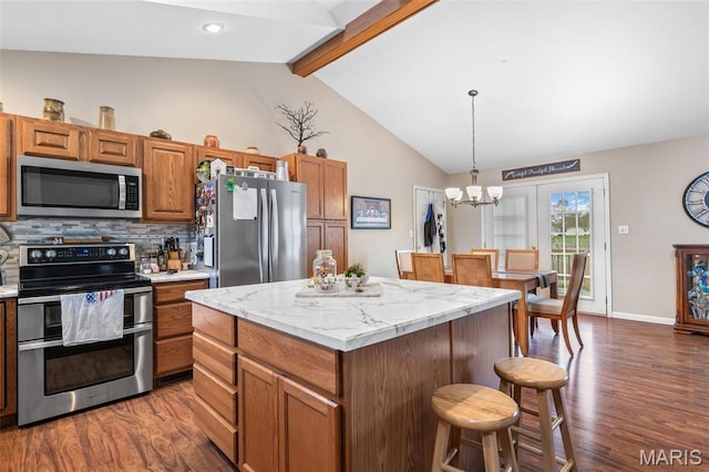 790 Isabella Ct, Farmington, MO 63640 - kitchen featuring appliances with stainless steel finishes, dark wood-type flooring, a kitchen breakfast bar, decorative light fixtures, and recessed lighting