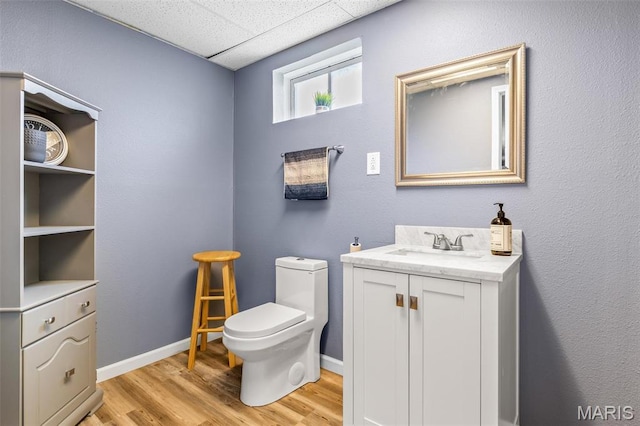 790 Isabella Ct, Farmington, MO 63640 - bathroom featuring a drop ceiling, toilet, wood finished floors, vanity, and baseboards