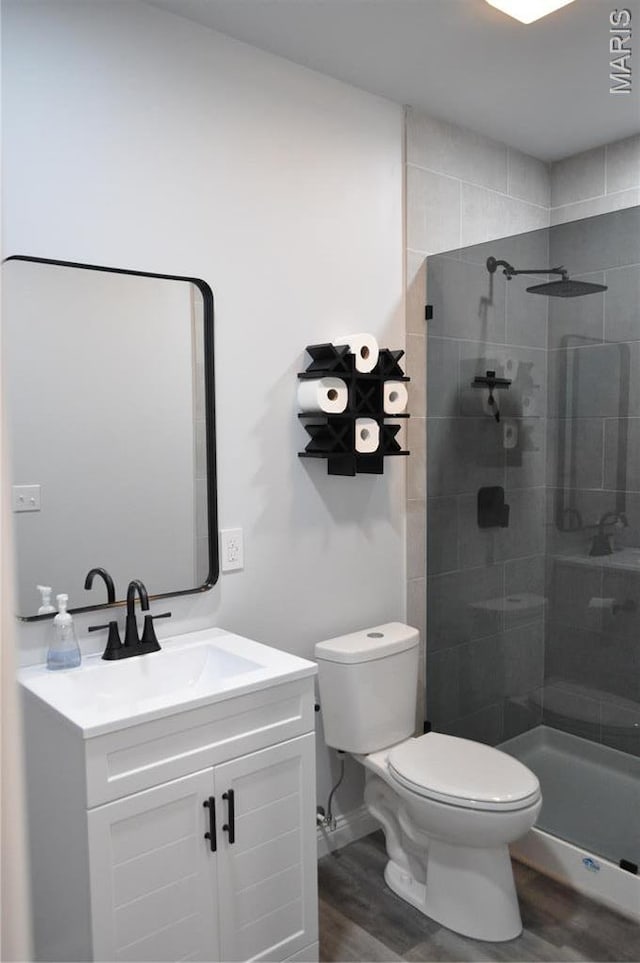 869 Destiny Dr, Villa Ridge, MO 63089 - full bathroom with wood finished floors, toilet, tiled shower, and vanity