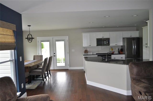869 Destiny Dr, Villa Ridge, MO 63089 - kitchen with stainless steel microwave, freestanding refrigerator, french doors, a sink, and white cabinets