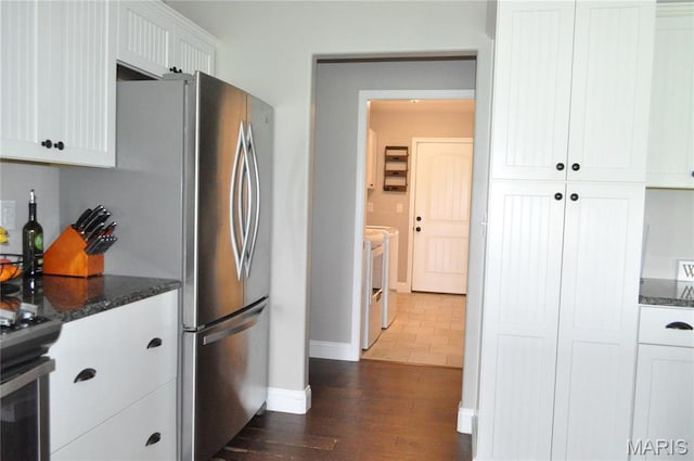 869 Destiny Dr, Villa Ridge, MO 63089 - kitchen featuring baseboards, dark wood finished floors, white cabinetry, dark stone countertops, and appliances with stainless steel finishes