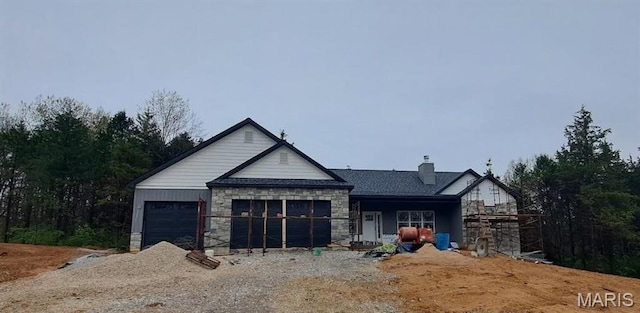 407 Shady Trail Dr, Troy, MO 63379 - view of front facade featuring stone siding, a garage, and a chimney