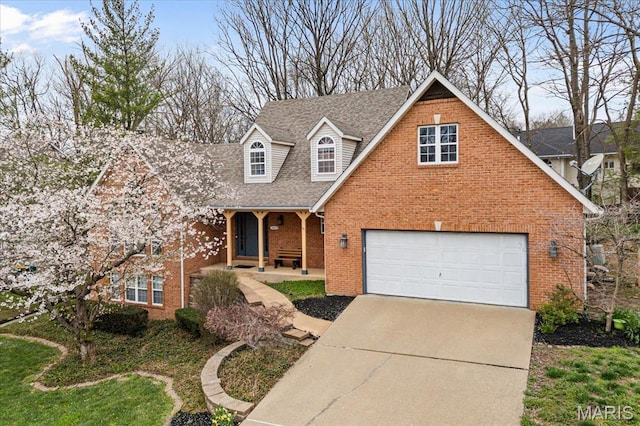 1029 Stonybrook Dr, Ofallon, IL 62269 - traditional-style house featuring brick siding, concrete driveway, roof with shingles, covered porch, and an attached garage