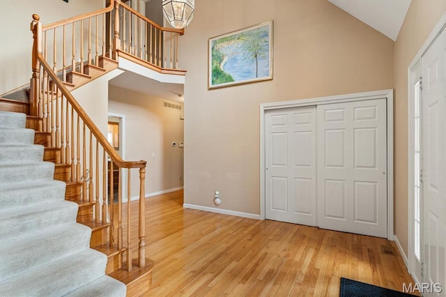 1029 Stonybrook Dr, Ofallon, IL 62269 - foyer entrance with hardwood / wood-style floors, stairway, baseboards, high vaulted ceiling, and plenty of natural light