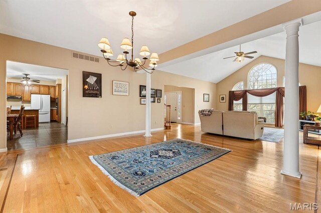 1029 Stonybrook Dr, Ofallon, IL 62269 - dining area with a ceiling fan, light wood-style flooring, decorative columns, vaulted ceiling, and baseboards