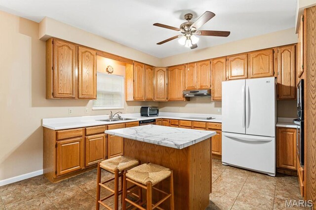 1029 Stonybrook Dr, Ofallon, IL 62269 - kitchen featuring freestanding refrigerator, under cabinet range hood, light countertops, black electric cooktop, and a ceiling fan
