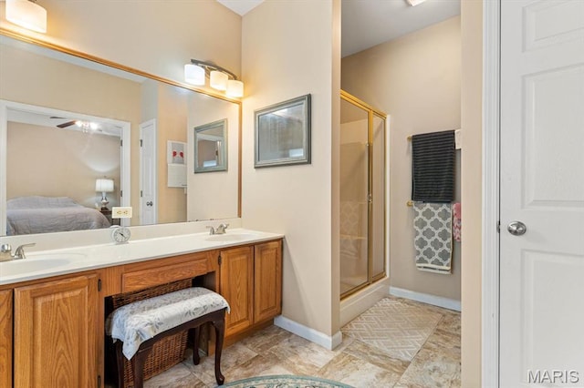 1029 Stonybrook Dr, Ofallon, IL 62269 - ensuite bathroom featuring a shower stall, double vanity, and baseboards